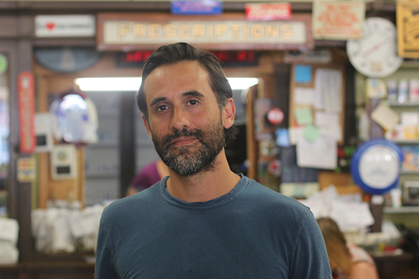 Man with brown hair, beard and mustache looking at camera