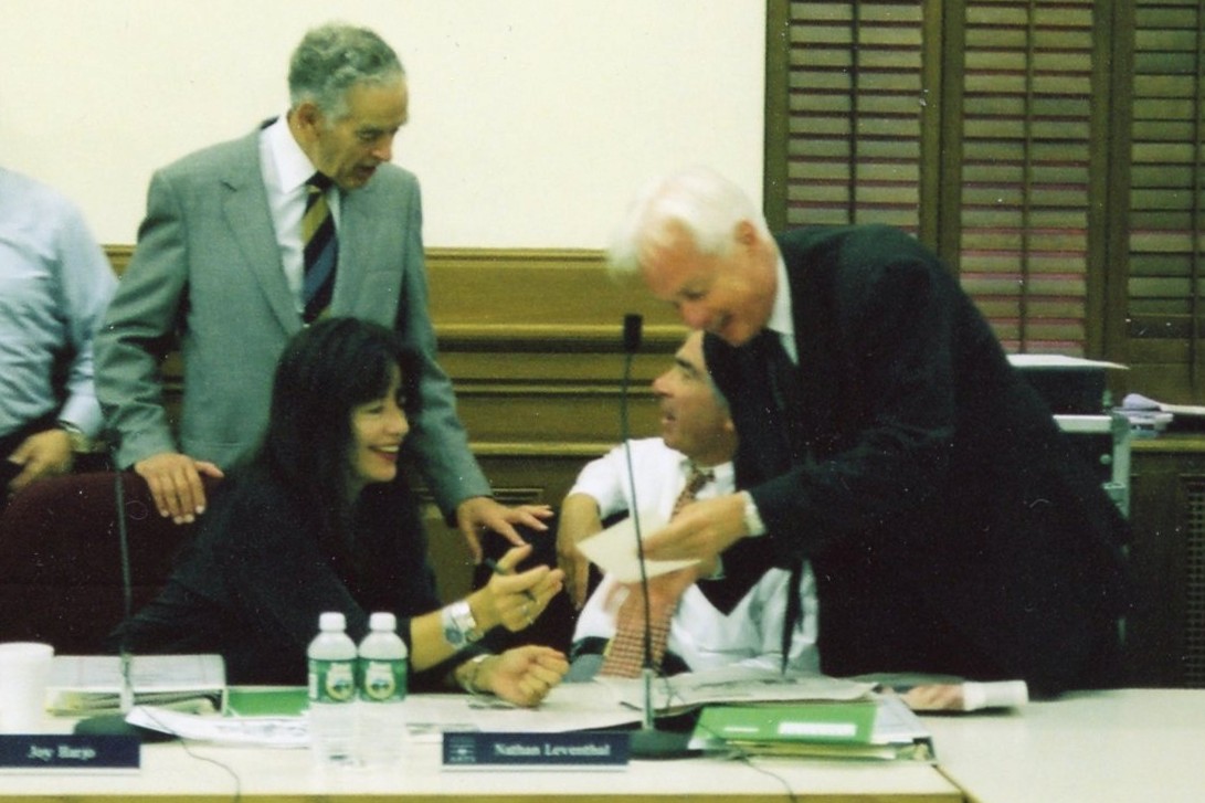Several people at a table during a meeting. 