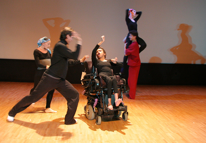 Woman in wheelchair dancing with other dancers.