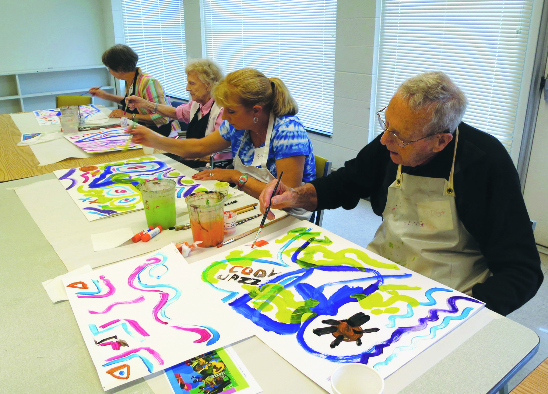 Elderly people with memory loss painting watercolor pictures. 