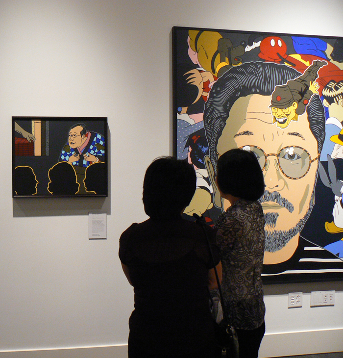 People looking at a museum exhibit. 