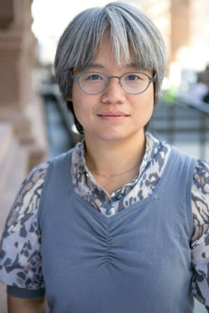 Woman with gray hair and glasses