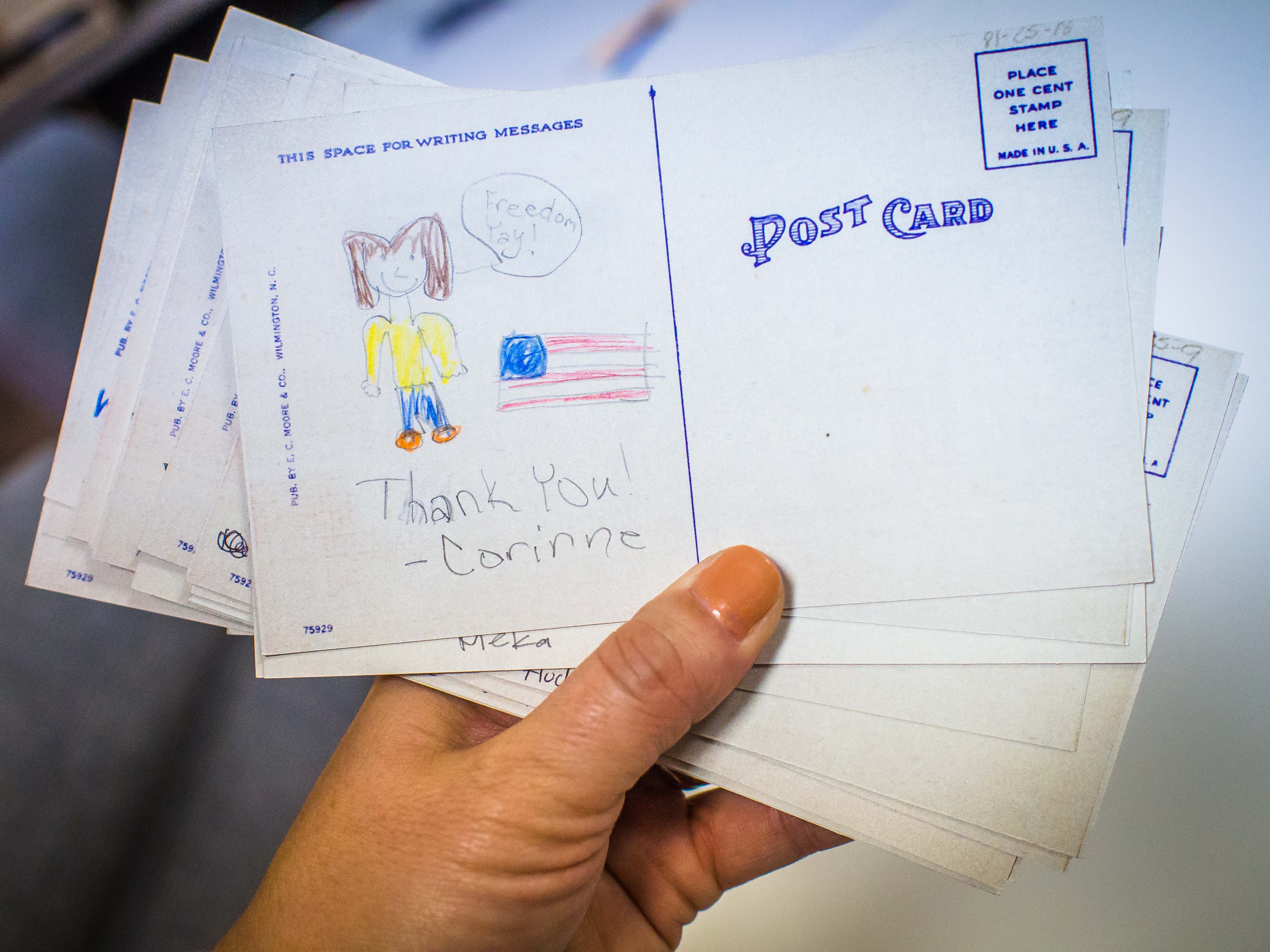 A postcard with a drawing by a child. The postcard reads, thank you. 