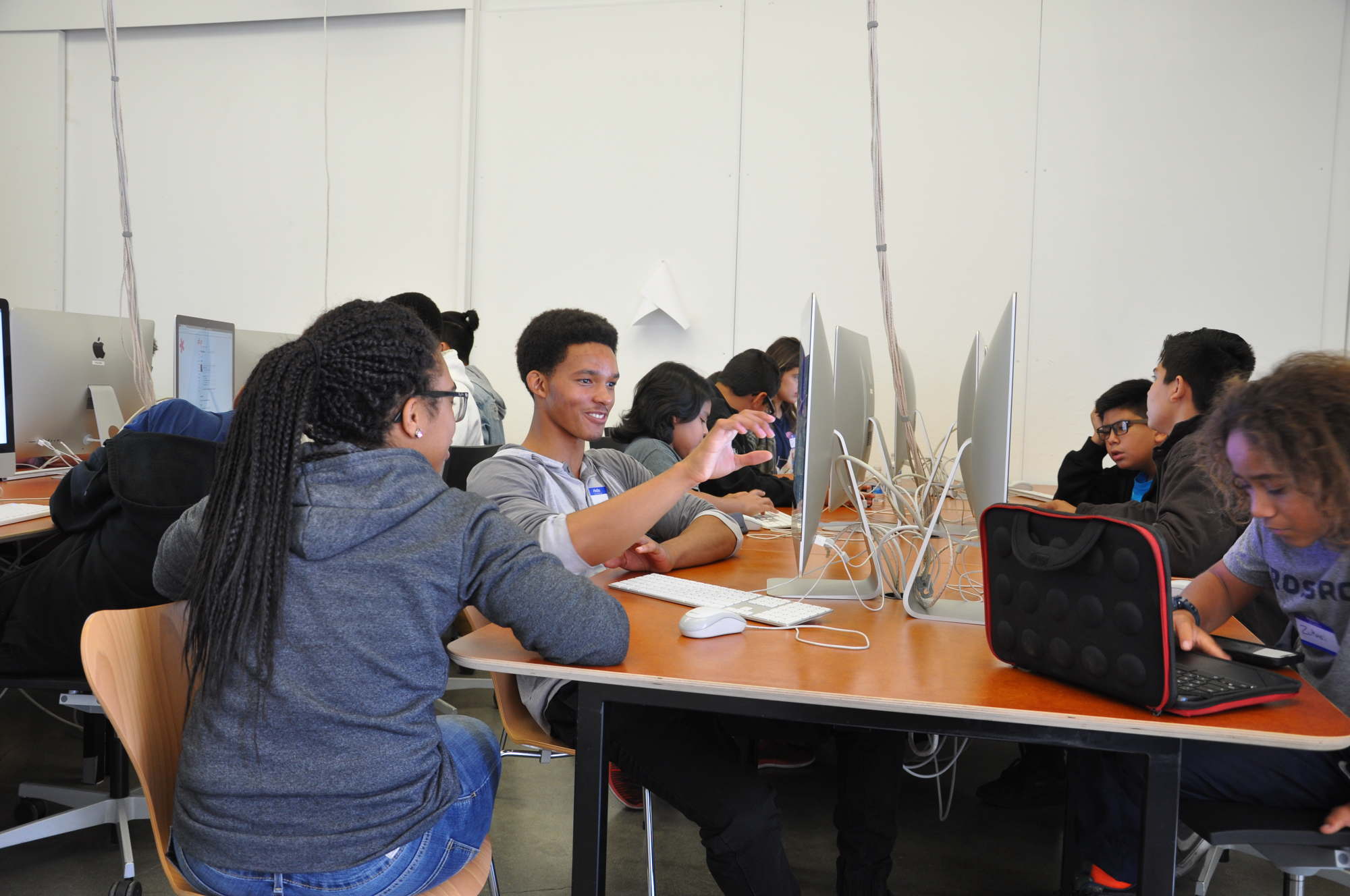 Students sit in front of computers