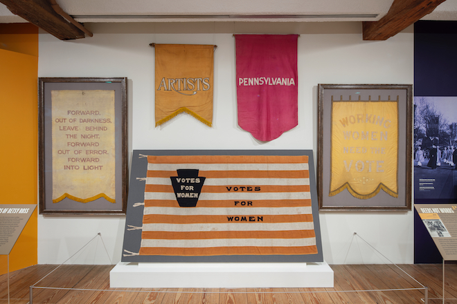 a collection of different sized felt banners with women's suffrage slogans