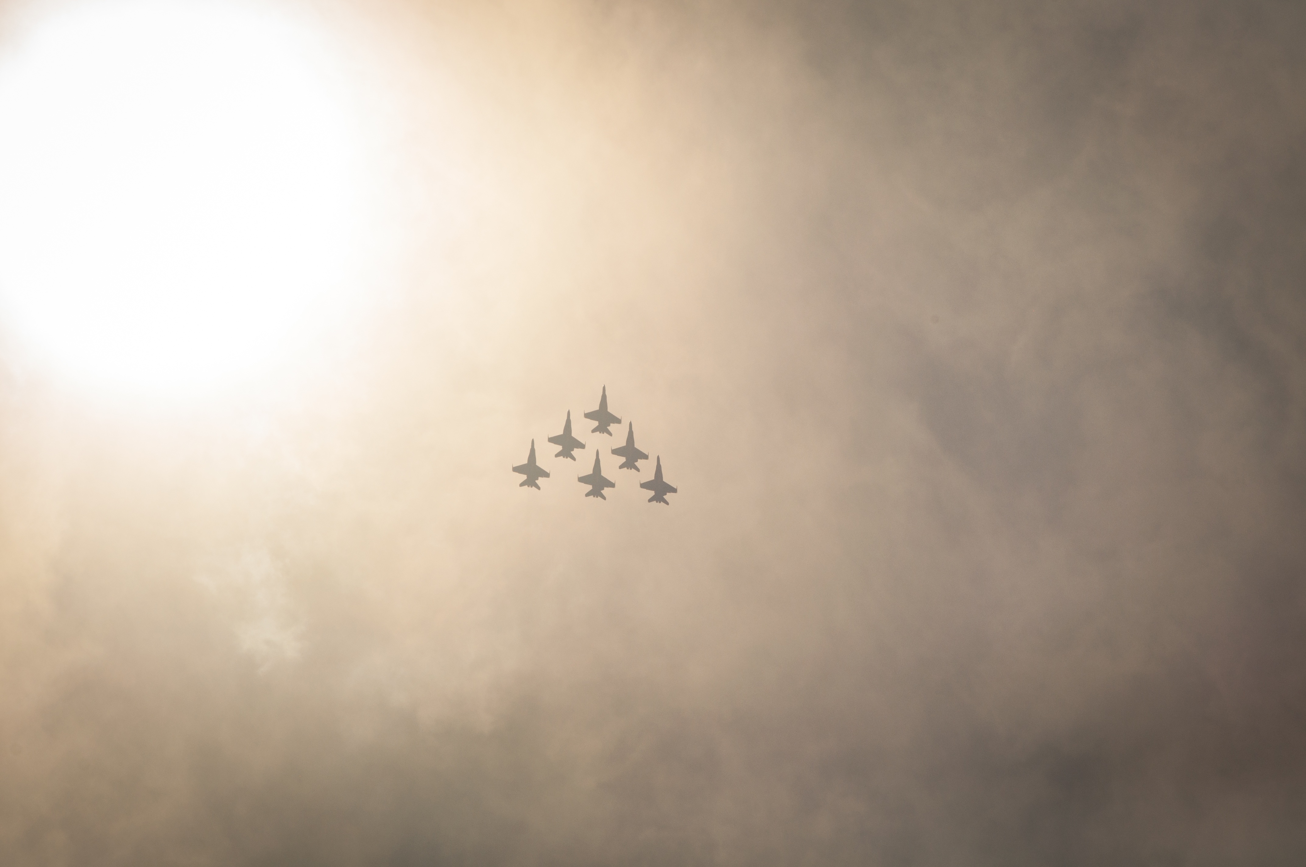 Six military aircraft flying in the sky.