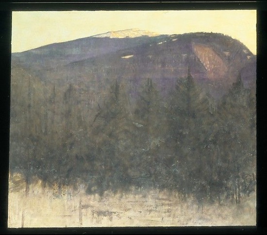Purplish snow-capped mountains in background with row of evergreens and snow plain in the foreground
