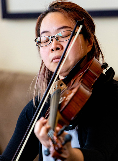 A woman plays a viola