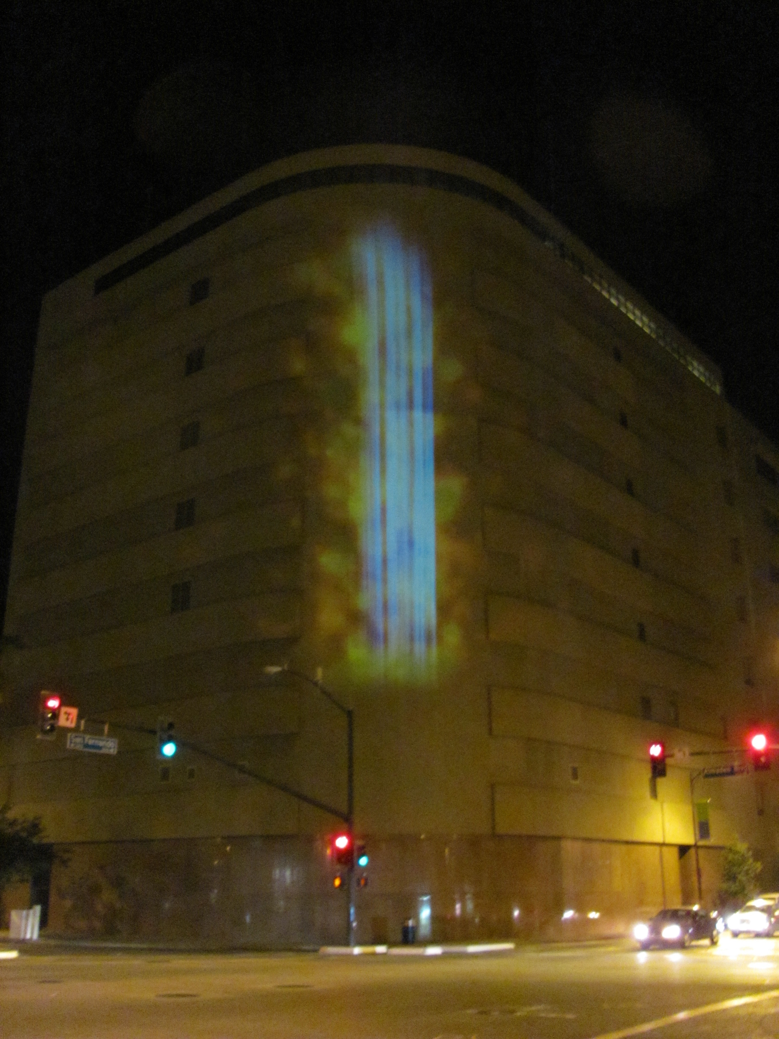 Bright blue lights on the side of an office building. 