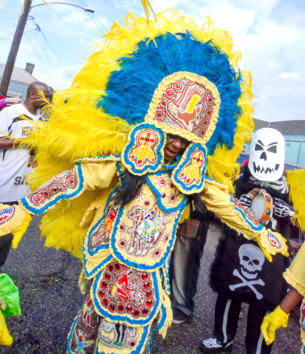 Man in a full body costume with intricate and colorful designs.