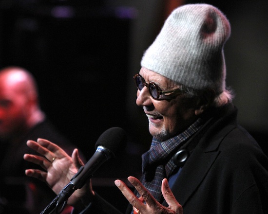 Tight shot of smiling NEA Jazz Master Charles Lloyd on stage wearing winter hat and sunglasses