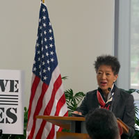 A woman at a podium.
