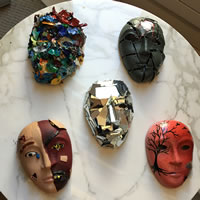 Masks made with different materials and colors on display.