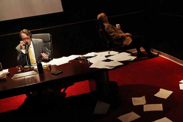 Man in a play in chair with papers scattered