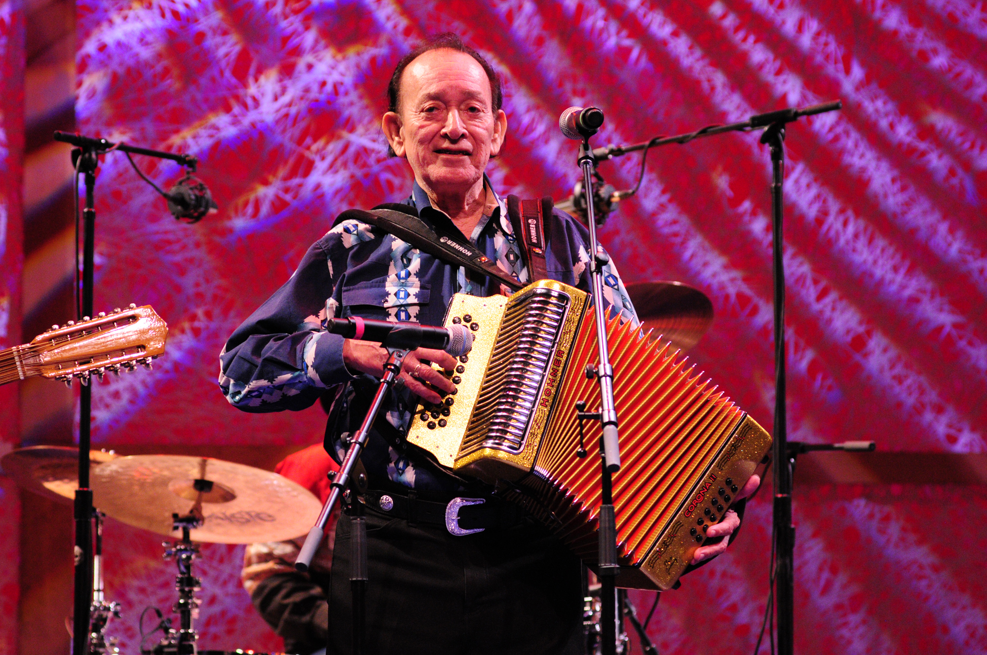 Man on stage playing accordion. 