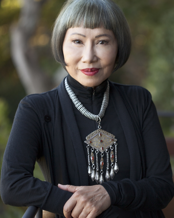 Portrait of a woman wearing a large pendant on her chest.