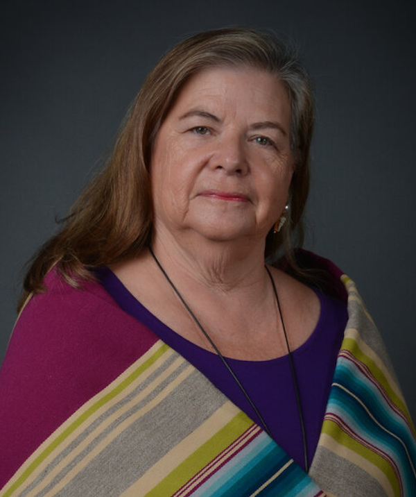 A woman wearing a woven shawl.