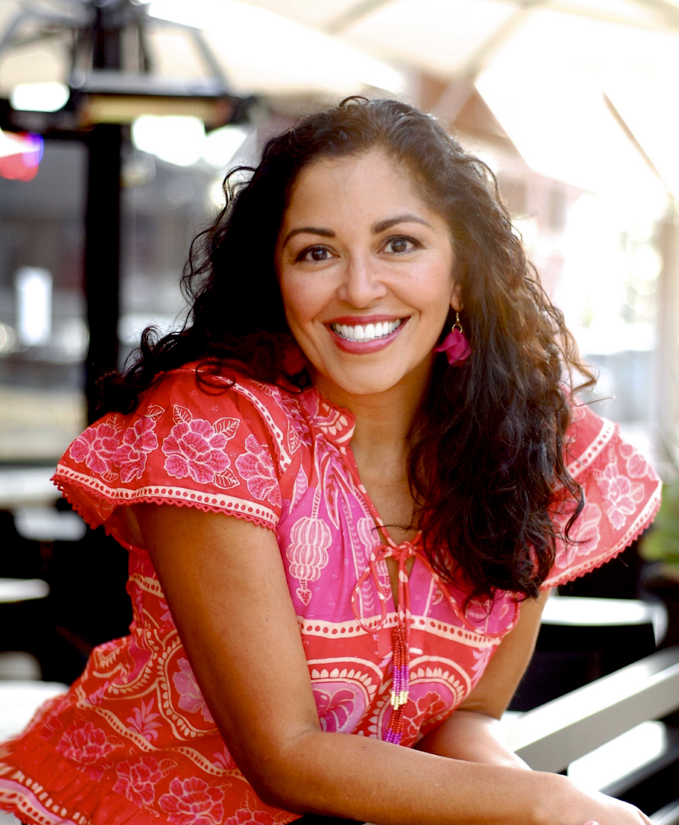 A young woman poses in red dress