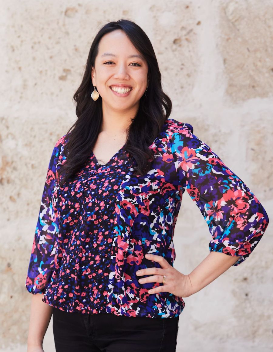 Photo of a woman with a flower pattern blouse.