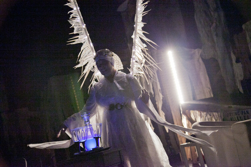 A character in a play dressed in white with white wings
