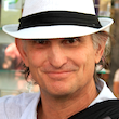 Headshot of a man with a hat.