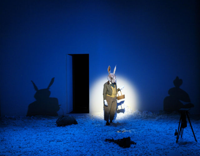 Actor dressed in rabbit suit standing on stage