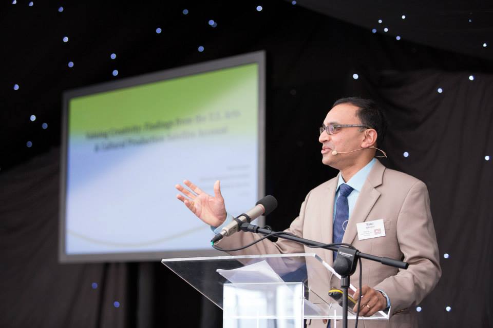 Man in suit speaking at a podium