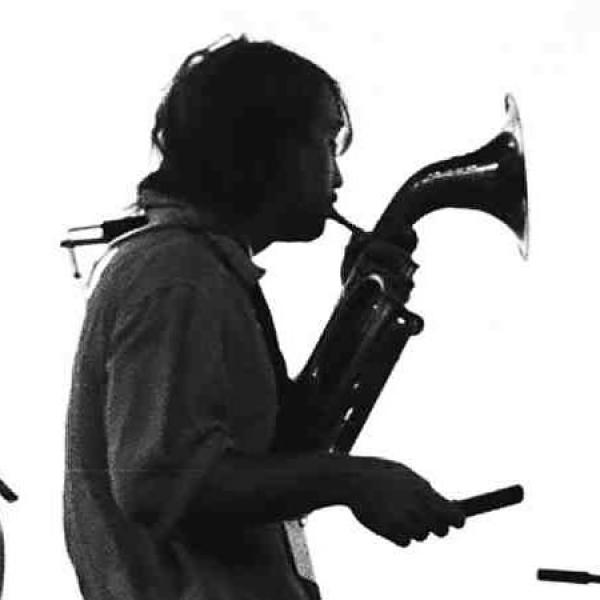 Man playing a horn on stage.