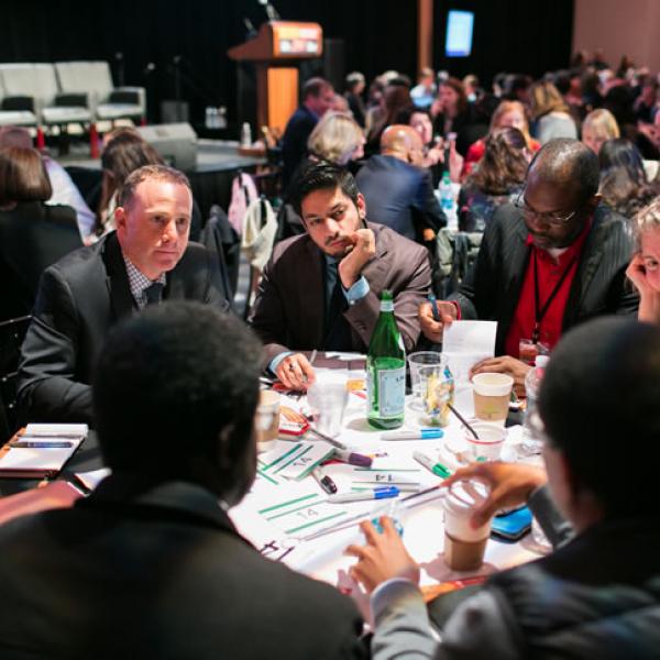 Table of conference attendees brainstorming