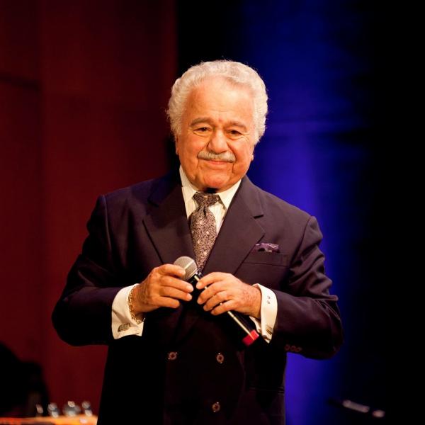 Man singing on stage. 