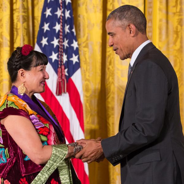 A man shakes hands with a woman
