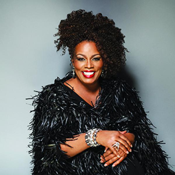 African-American woman wearing black furry dress. 