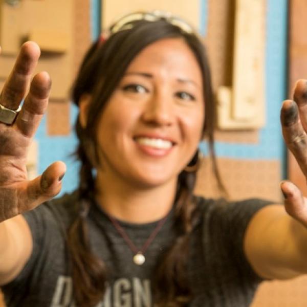 Woman holding out her hands full of ink. 