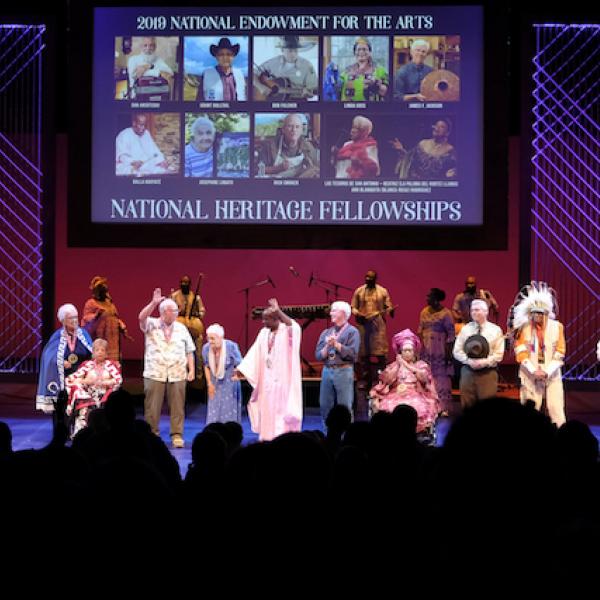 a group of diverse people on a lit stage