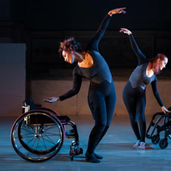 Two disabled dancers dancing with wheelchairs