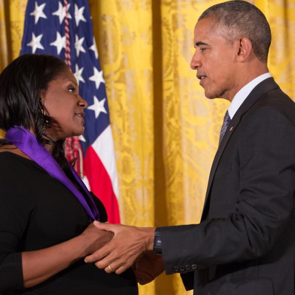 A man and a woman shake hands.