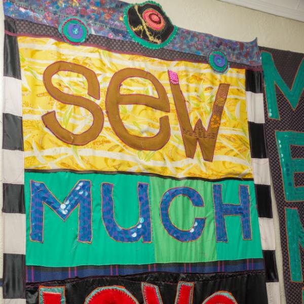 A colorful quilt that says Sew Much Love