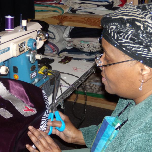 Woman sewing a quilt. 