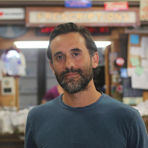 Man with brown hair, beard and mustache looking at camera