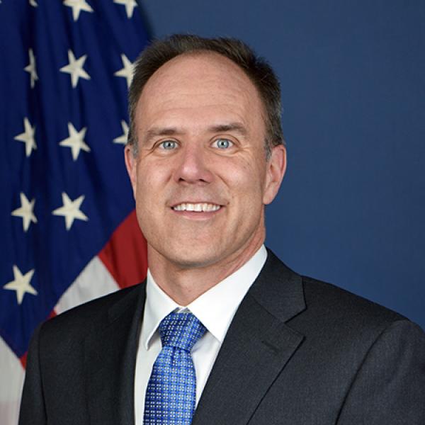 Portrait of Chris Gerdes in front of U.S. flag.