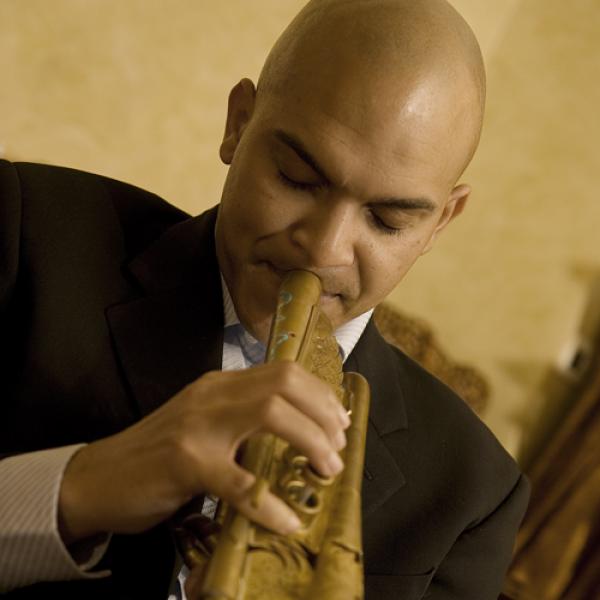 African-American man playing trumpet. 