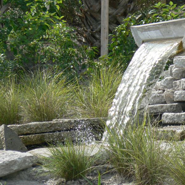 A fountain made of a cut stormwater pipe