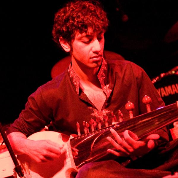 Man playing the stringed instrument, the sarod.