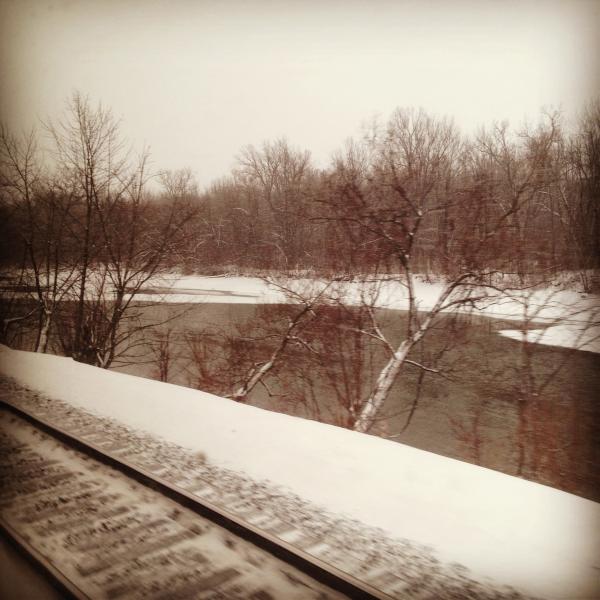 Railroad tracks photo taken from inside of train out the window. 