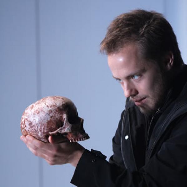 Man gazing at a skull