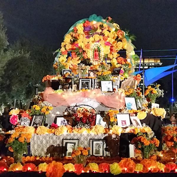 A large flower altar in an outdoor setting at night.