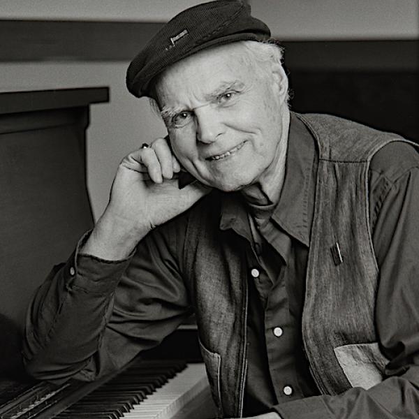 Portrait of Bob McQuillen sitting at the piano