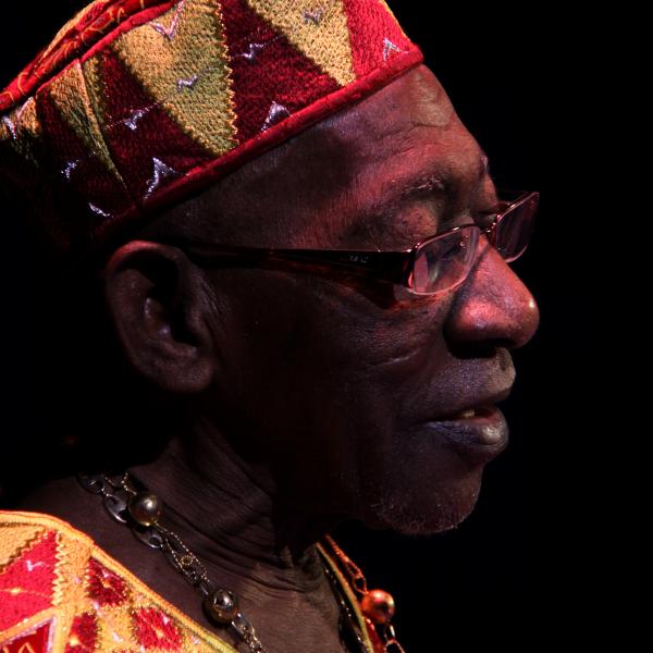 Man in African garb on stage.