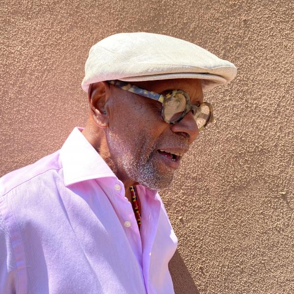 Portrait of man in cap wearing glasses. 