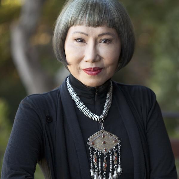 Portrait of a woman wearing a large pendant on her chest.